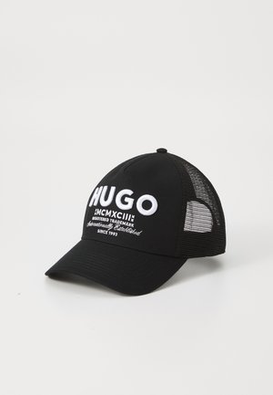 Sort baseball cap med broderet "HUGO" i hvid skrift, med en solid front og mesh bag til ventilation. Design med buet skygge.