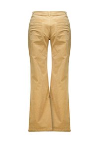 Pantalons évasés en velours côtelé beige avec une taille haute, deux poches arrière et une texture lisse. Les jambes s'élargissent vers l'ourlet.