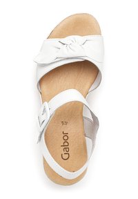 White leather sandal with a knot detail on the strap, adjustable buckle, and a cushioned footbed featuring the brand name "Gabor" printed on it.