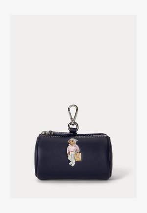 Sjømannsblå sylinderformet myntlomme med glidelåstrekk og sølvfarget klemme, med en bjørneillustrasjon kledd i hvite bukser og stripete skjorte.