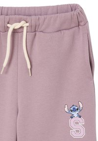 Light purple sweatpants with an elastic waistband, cream drawstring, and a printed Stitch character with a white "S" letter accent.