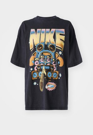 Black cotton T-shirt featuring a large, colorful graphic with the word "NIKE" and a boombox design, accented by speaker illustrations and circles.