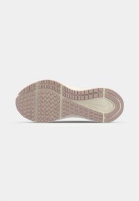 Light-colored sneaker outsole with a textured grip pattern; features pink rubber accents and a smooth, light-colored midsole.