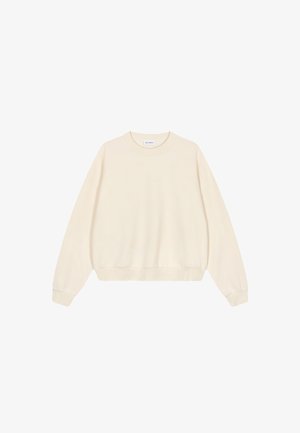 Felpa color crema con collo rotondo, spalle scese, polsini e orlo a costine. Realizzata in tessuto morbido, presenta un'etichetta del marchio discreta.