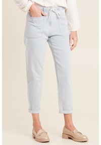 Lichtblauwe denimbroeken met een elastische tailleband, verstelbare koorden, twee voorzakken en opgerolde boorden. Geweven stof met een zachte afwerking.