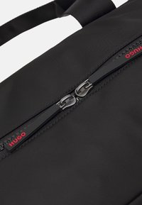 HUGO ETHON HOLDALL UNISEX - Víkendová taška - black