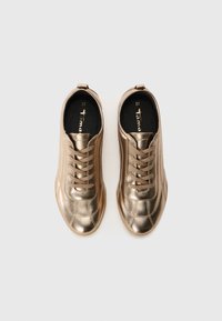 Metallic bronze sneakers with a low silhouette, round toe, and tonal laces. Features a textured finish and brand logo on the insole. Size 37.