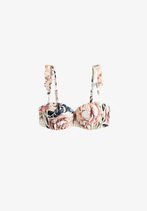 Bralette floral avec des bretelles volantes, présentant de grandes fleurs roses et navy sur un fond crème, fabriqué en tissu doux avec un design froncé.