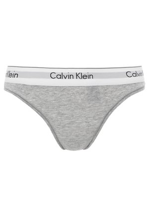 Grå bomullsunderdel med vit midjeband som har svart "Calvin Klein"-logotyp. Slät textur och låg midja för vardagligt bruk.