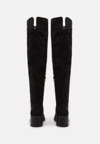 Knee-high black suede boots with a slight heel, featuring a split shaft design and side zippers for easy wear.