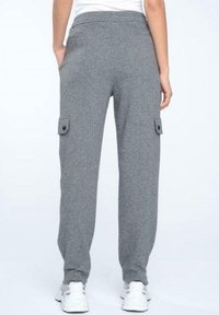 Gray cargo pants feature a relaxed fit, elastic waistband, side pockets, and a textured fabric. Additional details include buttoned utility pockets.