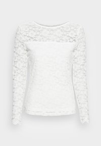 Haut blanc en dentelle à manches longues avec un motif floral, encolure arrondie et bords de manches festonnés, avec une coupe cintrée à la taille.