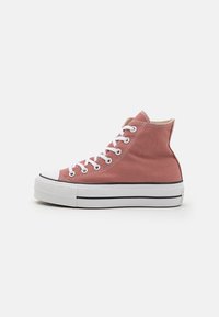 Pink high-top canvas sneaker with white rubber sole, round toe, contrasting black stripe, and white laces. Raw edge at collar.
