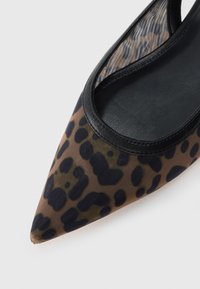 Leopard-print pointed-toe shoe with a transparent mesh upper and black leather trim, featuring a smooth, textured surface.