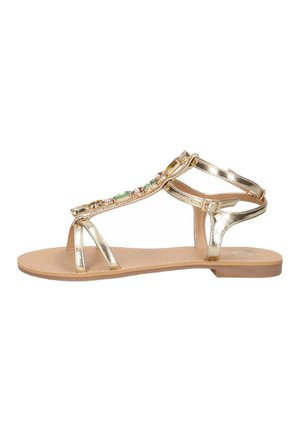 Sandalo piatto oro con fibbia alla caviglia, anello per l’alluce e pietre decorative multicolori lungo la fascia a T.
