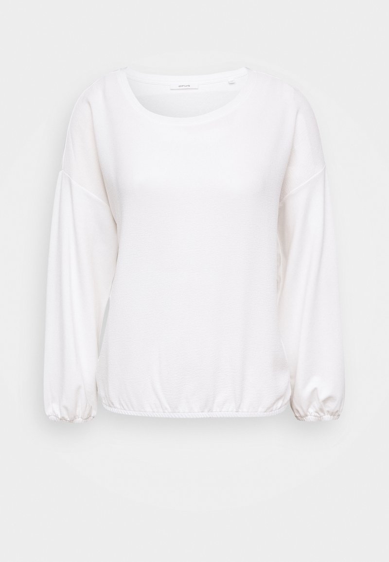 Vit långärmad topp med rund halsringning, samlade ärmslut och en mjukt texturerad tygkvalitet, med en avslappnad passform och elastisk nederkant.