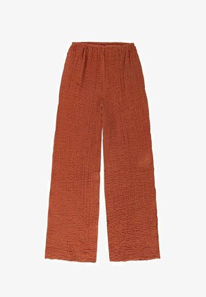 Spodnie szerokie w kolorze rdzawego pomarańczu, wykonane z fakturowanej tkaniny o pomarszczonym wzorze. Elastyczna talia dla regulowanego dopasowania. Brak widocznych kieszeni.