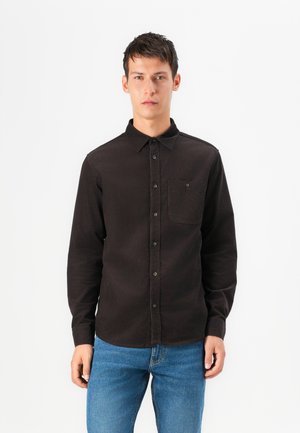 Black long-sleeve shirt made of soft fabric, featuring a button-down collar and a chest pocket. Simple design with a straight cut.