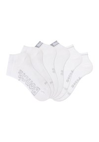 White cotton ankle socks, featuring a reinforced heel and toe, with gray logo accents and subtle ribbed texture. Set of six pairs.