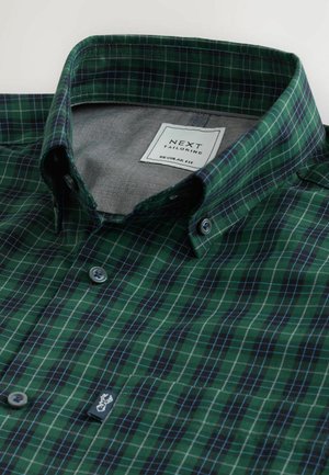 Vihreä ruudullinen paita, jossa on nappikiinnitteinen kaulus, kontrastivärinen harmaa vuori ja siniset korostevuoraukset. Tavallinen mitoitus.