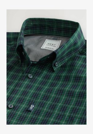 Vihreä ruudullinen paita, jossa on nappikiinnitteinen kaulus, kontrastivärinen harmaa vuori ja siniset korostevuoraukset. Tavallinen mitoitus.