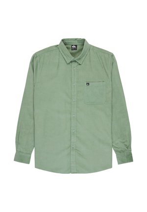 Green corduroy shirt with long sleeves, classic collar, front pocket, and button closure. Textured fabric with subtle vertical lines.