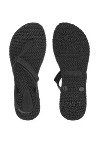 Black sandals with textured rubber soles, flat design, adjustable straps, and logos embossed on the footbed and outsole.