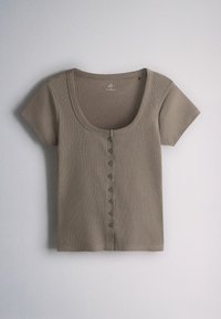 Short-sleeve taupe knit top with scoop neckline and a front row of small buttons, laid flat on a light surface.