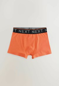 Oranga bomullshorts i boxermodell med svart elastiskt midjeband där "NEXT" är tryckt i grått. Klassisk form med en mjuk yta.