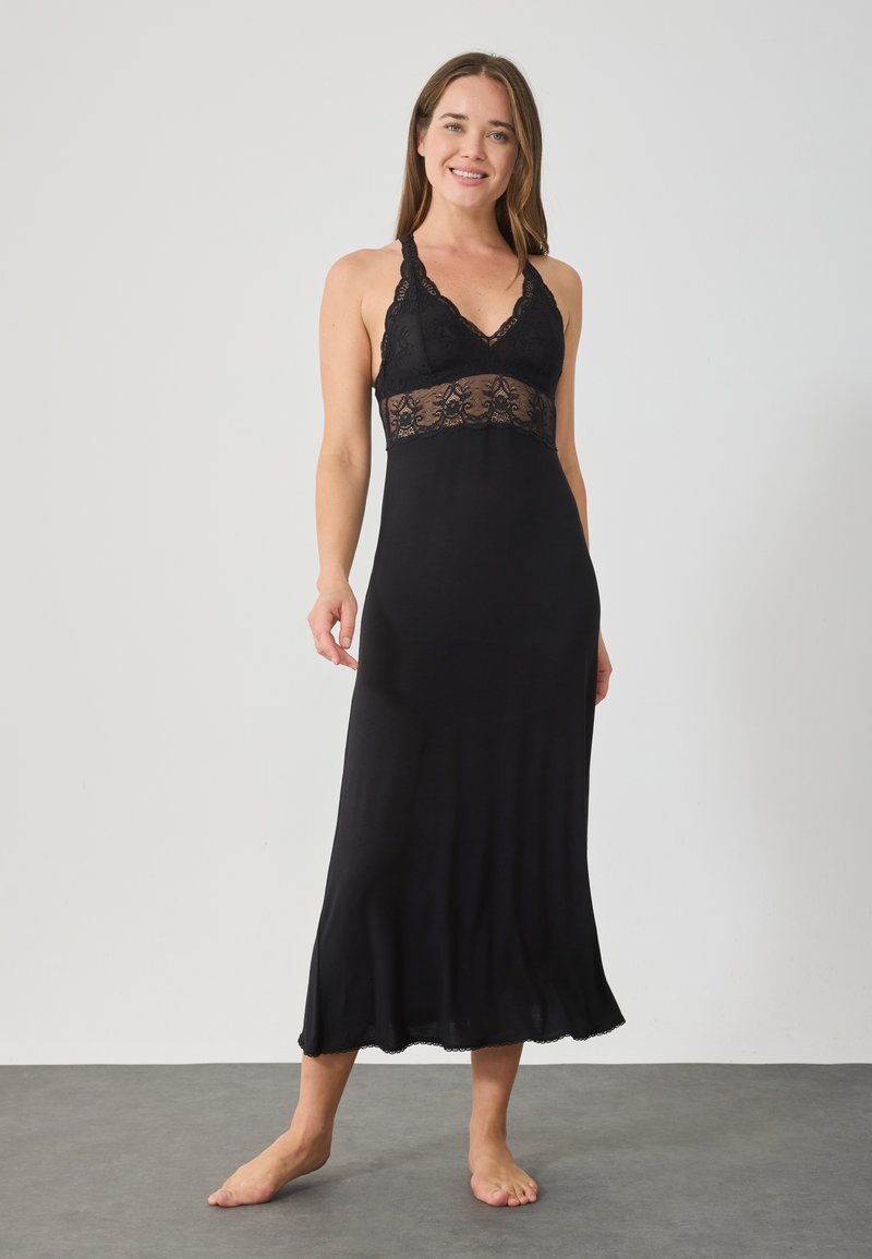 Camisa de noche negra con un corpiño de encaje y un dobladillo fluido. Presenta un diseño de cuello halter y una textura suave y lisa.