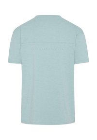 Šviesiai mėlynas trumpomis rankovėmis marškinėliai, pagaminti iš minkštos medžiagos. Turi lygią tekstūrą su tekstiniu detalizavimu nugarinėje pusėje. Klasikinio apskritimo kaklo dizainas.