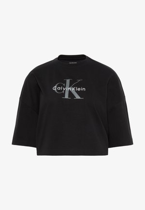 Μαύρο κοντό υπερμεγέθες T-shirt με φαρδιά μανίκια και γκρι λογότυπο "CK Calvin Klein" τυπωμένο στο κέντρο μπροστά.