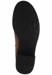 Talón de ante marrón con suela de goma negra que presenta patrones de agarre texturizados. Logo "Gabor" visible en el lateral de la suela.