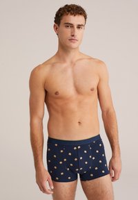 Sötétkék boxer alsónadrág sárga derékrésszel, kis hamburger ikonok mintájával. Puha, rugalmas anyagból készült.