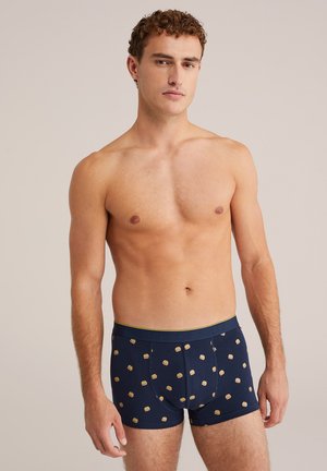 Navy boxer briefs with a yellow waistband, featuring a pattern of small hamburger icons. Made from a soft, stretchy material.