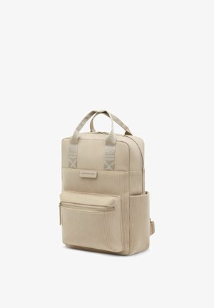 Sac à dos rectangulaire beige avec poche avant texturée, double poignée supérieure, poches latérales, fermeture éclair et étiquette « Kapten & Son » à l'avant.