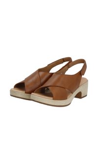 Brown leather sandals with open toe and cross-strap design, featuring a cork-look heel and a soft footbed for comfort.