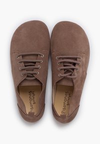 Brown suede shoes with rounded toes and front lacing. Features metal eyelets and a soft inner lining. Minimalistic design with no patterns.