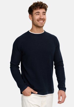Navy blue long-sleeve sweater with a textured knit pattern, contrasting white crew neckline, and a relaxed fit. Features ribbed cuffs and hem.