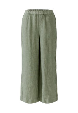 Pantalon large en lin vert olive avec taille élastique et coutures verticales surpiquées, longueur raccourcie.