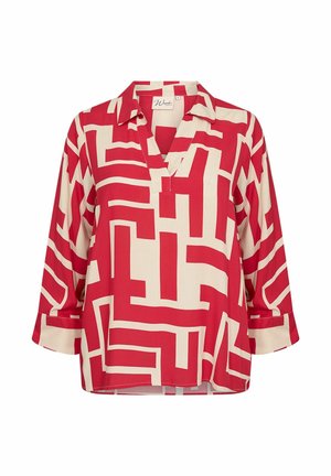 Blusa rossa e crema con un motivo geometrico, dotata di colletto a V, maniche a tre quarti e una vestibilità rilassata. Tessuto dalla texture liscia.