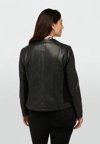 Black leather jacket with a fitted design, featuring a structured collar, back seam details, and a smooth texture.