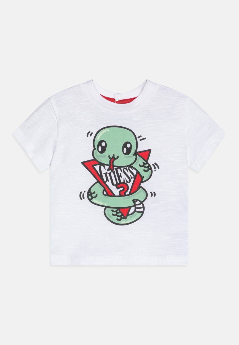White short-sleeve t-shirt featuring a cartoon green snake wrapped around a red triangle with "GUESS?" text in black. Soft, plain texture.