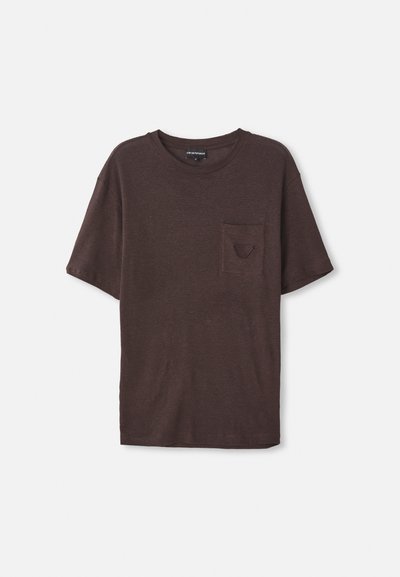 Ruda trumpa rankovė t-shirt, pagaminta iš minkštos, tekstūruotos medžiagos, su maža kišene kairėje pusėje ir apvaliu kaklu.