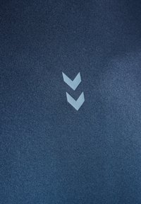 Dark blue fabric with a smooth texture featuring two light blue chevrons printed near the center.