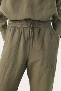 Olijfgroene, lichte broek met een elastische tailleband, verstelbaar trekkoord en zijzakken. Getextureerde stof met een relaxte pasvorm.