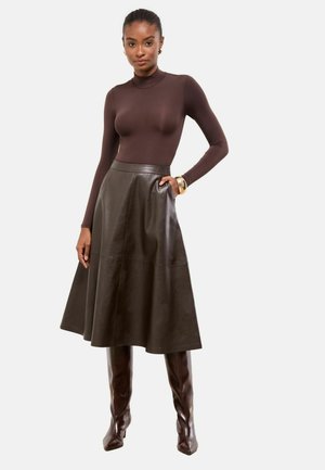 Brown long-sleeve bodysuit paired with a high-waisted, dark brown leather flared skirt and knee-high brown boots, showcasing a sleek design.