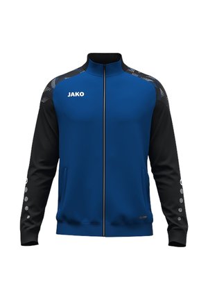 Chaqueta deportiva azul y negra con cremallera completa, cuello alto, logo JAKO en el pecho, franjas decorativas en los hombros y puntos en las mangas.