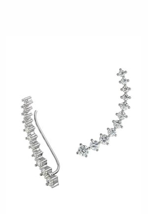 Silver earrings featuring a linear design, adorned with round, clear gemstones. One earring has a curved shape with stones gradually increasing in size.