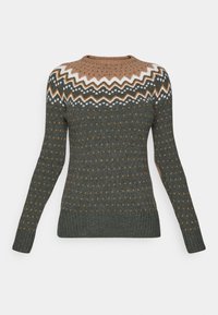 Knit sweater in dark green with a tan and white patterned yoke, featuring small orange dots. Ribbed cuffs and hem for added texture.